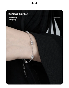 Wearing display of vintage silver S925 bracelet with oval gems on a black background