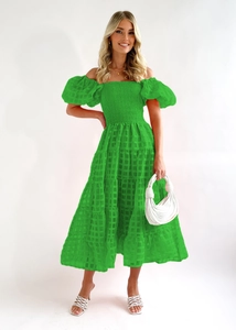 Detail of green off-shoulder dress with embossed plaid texture and tiered cake skirt