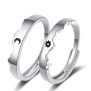 Detailed close-up of adjustable silver sun and moon rings with polished mirror finish
