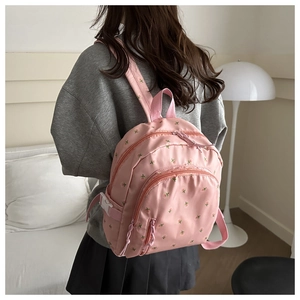 Pink floral print small backpack detail featuring smooth fabric and zipper pocket