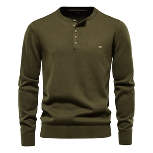 Detail view of olive green knit sweater showing the buttoned Henley neck and ribbed texture