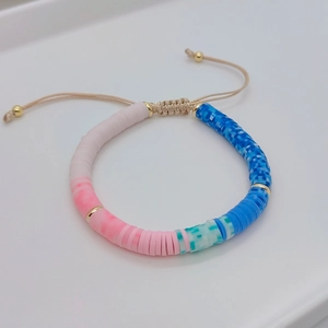 Detail of colorful Heishi beads and natural pearl bracelet with adjustable cord