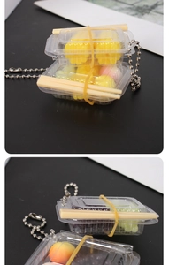 Miniature food keychain with multi-colored fake dim sum in a tiny takeout box