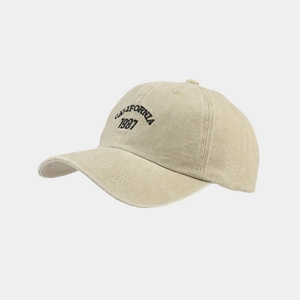 Close-up of California 1987 embroidery on a soft top beige vintage baseball cap