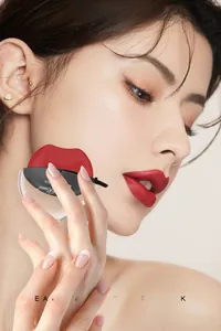 Lip-shaped matte lipstick in bright red applied by model for quick effortless finish