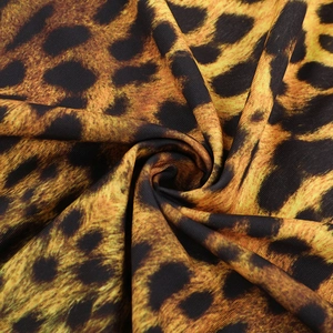 Detailed macro view of soft leopard print fabric with draped textures and knit pattern