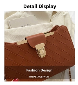 Close-up of brown woven underarm bag with gold metal buckle and chain strap detail