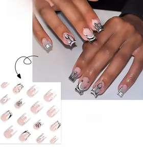 Detail of square nude nails featuring silver flame patterns and metallic cross accents