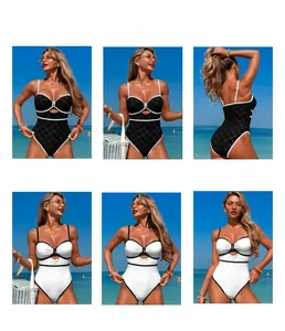 Detail view of one-piece swimsuit with contrast piping, cutout bow, and beach scene