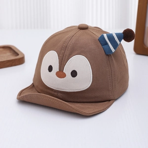 Close-up of cute penguin embroidery and striped knit decor on soft cotton baby cap