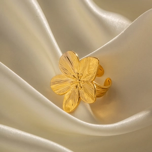 Matte gold vintage stainless steel flower open ring on beige silk background