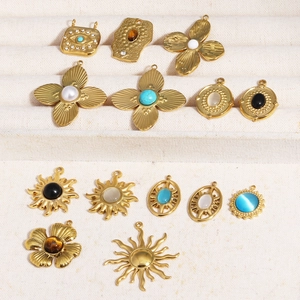 Detailed display of vintage cat eye stone and crystal pendants on a jewelry stand