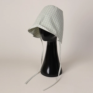 Detail of green plaid bucket hat showing wide brim and vintage long ribbon straps