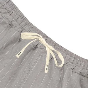 Detail of elastic waistband and drawstring on striped linen blend summer shorts