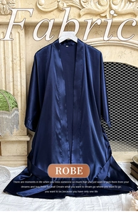 Detail view of smooth silk-like satin fabric texture on this dark blue luxury robe