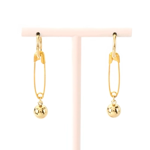 Minimalist gold stainless steel safety pin earrings with polished ball pendant on pink stand