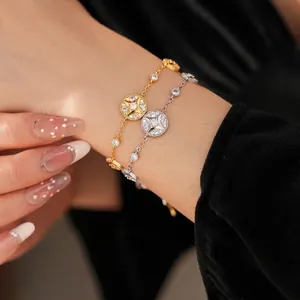 18K gold and silver plated zircon starburst bracelets shown on a model wrist