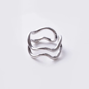 Detailed top view of a minimalist silver wavy adjustable open ring with a polished finish