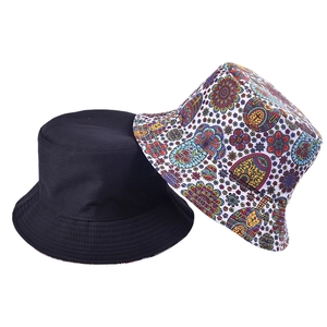 Detail showing classic black and vibrant geometric ethnic print double-sided cotton bucket hat