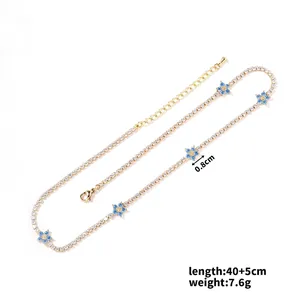 Detail of gold floral necklace with blue zircon flowers, 40+5cm length and 0.8cm charms