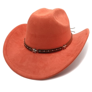Detail of a rust-red faux suede cowboy hat featuring a leather band with silver star studs