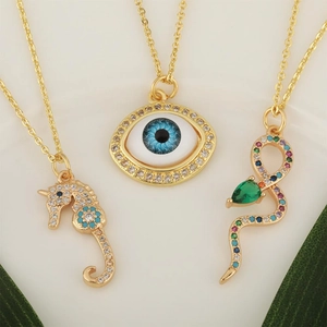 Gold-plated necklaces featuring a sea horse, evil eye, and colorful zirconia snake pendants