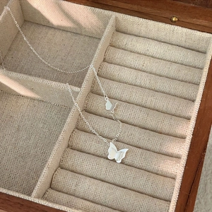 Minimalist 925 sterling silver butterfly choker necklace in a beige jewelry box