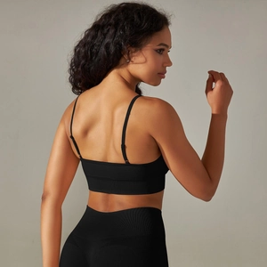 Detail of cross-back straps on seamless black sports bra and high waist leggings set