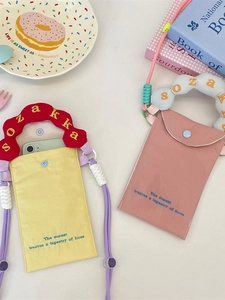Mini canvas crossbody phone bag with wavy embroidered handle and colorful woven strap