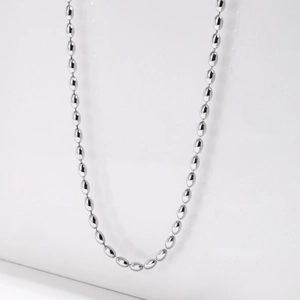 Detailed view of silver oval bead titanium steel necklace showing glossy metallic luster
