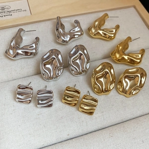 Minimalist gold and silver crinkled acrylic geometric stud earrings set in a tray