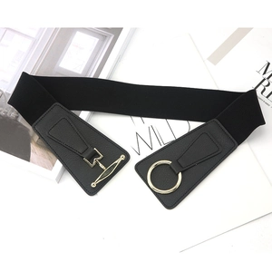 Detail of black elastic belt with golden metal buckle on a white background texture