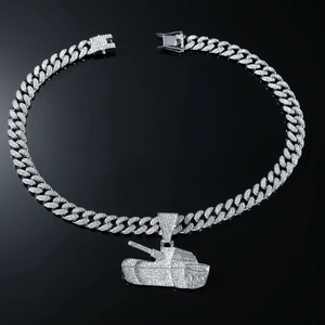 Detailed macro view of silver Cuban link chain with a sparkling iced out tank pendant