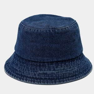 Close-up of durable dark blue denim fabric texture and stitching on sun bucket hat