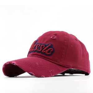 Close-up of vintage burgundy cotton cap with Classic embroidery and distressed details