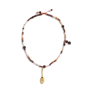 Bohemian beaded necklace featuring wooden beads and a golden spoon pendant with yellow gem