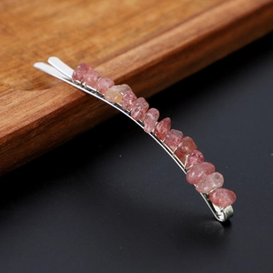 Macro view of natural strawberry quartz stones on a silver metal hair clip detail