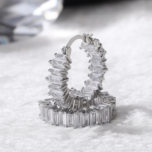Macro view of silver hoop earrings with baguette cut AAA cubic zirconia stones