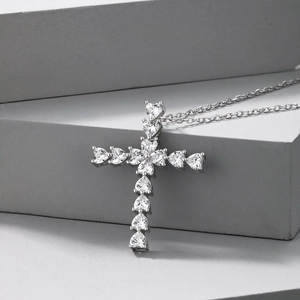 Detail of S925 silver cross pendant featuring heart-shaped cubic zirconia on stone base