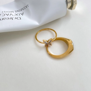 Detail of gold butterfly ring set with marquise zircon and wide polished band
