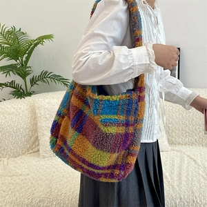 Detailed macro view of a colorful plaid plush tote bag made of soft sherpa wool material