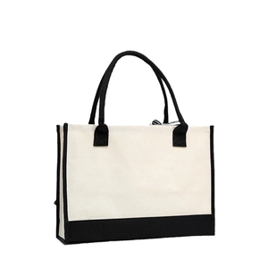 Classic cotton canvas tote bag with black trim and handles, professional studio product shot