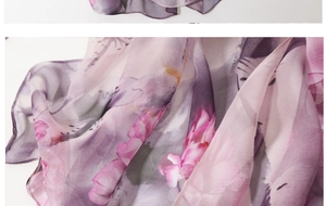 Close-up of semi-transparent chiffon fabric with purple and pink watercolor floral patterns