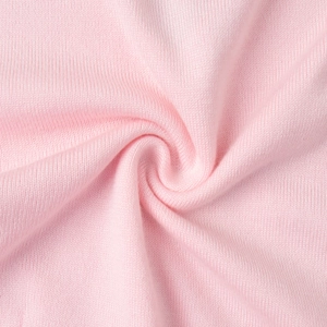 Close-up of soft pink knit fabric texture showing vertical ribbed details and elasticity