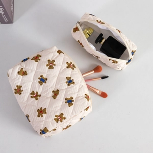 Quilted beige cosmetic bag set featuring cute bear patterns and top zipper closure
