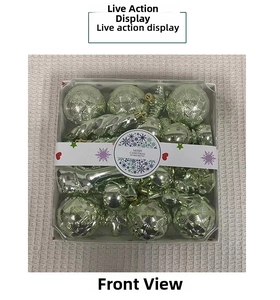 Macro view of silver-green Christmas ornaments with diverse textures in festive gift packaging
