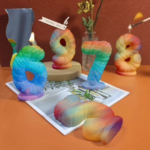 Rainbow gradient number 6-9 candles with spiral woven texture on wooden tray