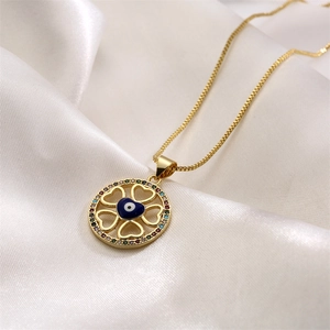 Detailed macro of gold plated evil eye pendant necklace with colorful cubic zirconia