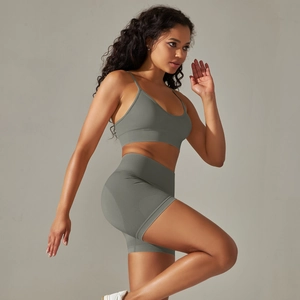 Detailed side view of seamless ribbed sports bra and high-waisted gym shorts in sage green