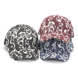 Three paisley pattern baseball hats in black, red, and blue with jacquard fabric
